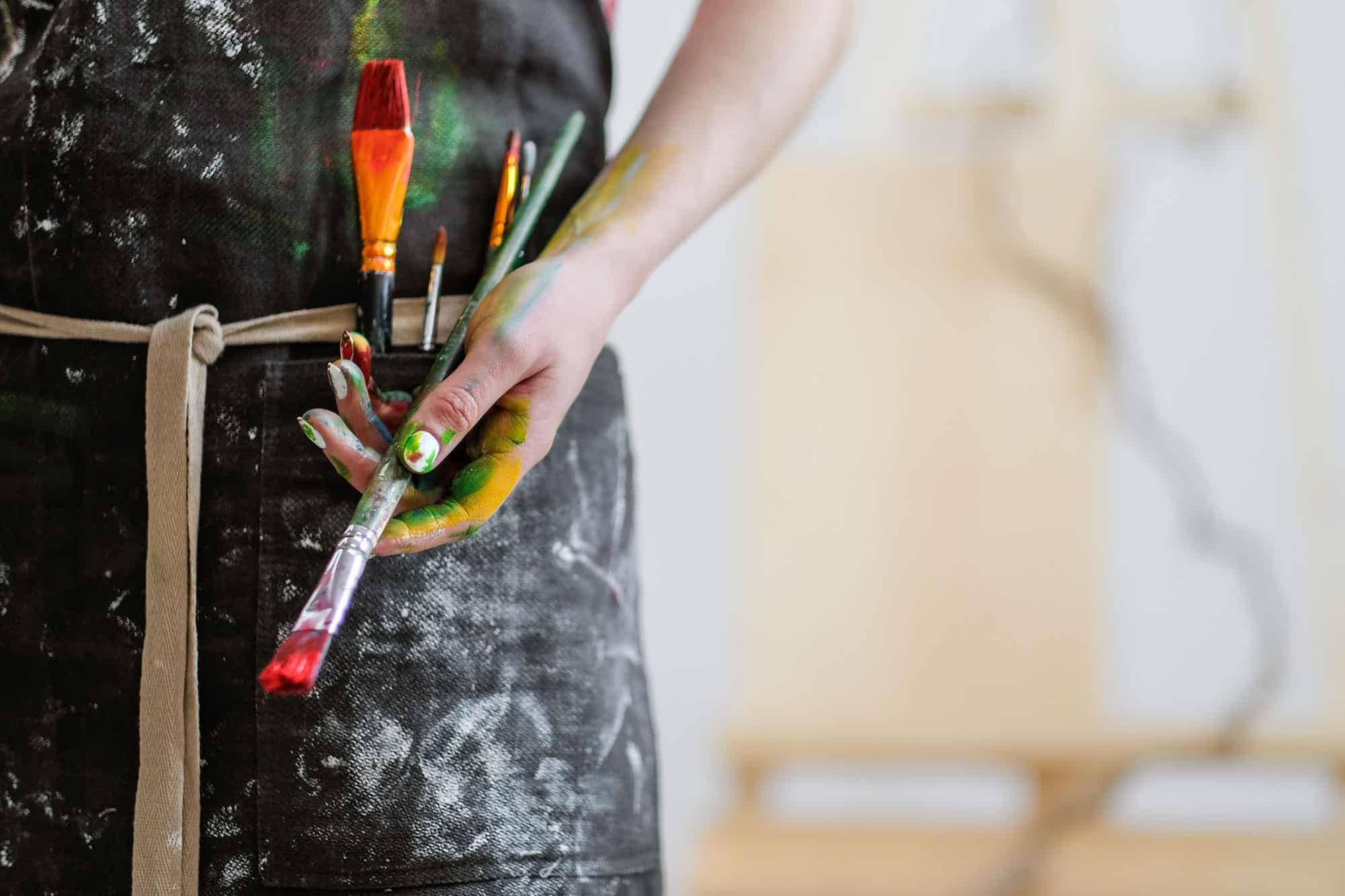 woman holding paint brushes